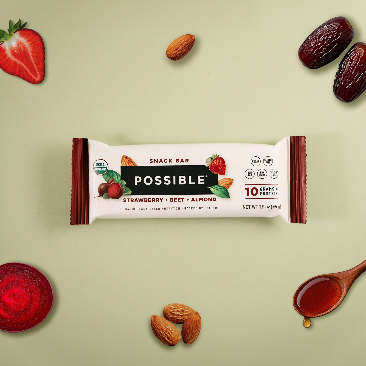 POSSIBLE Strawberry Beet Almond Snack Bar displayed with whole food ingredients including strawberries, beets, almonds, and a drizzle of syrup, emphasizing plant-based nutrition.