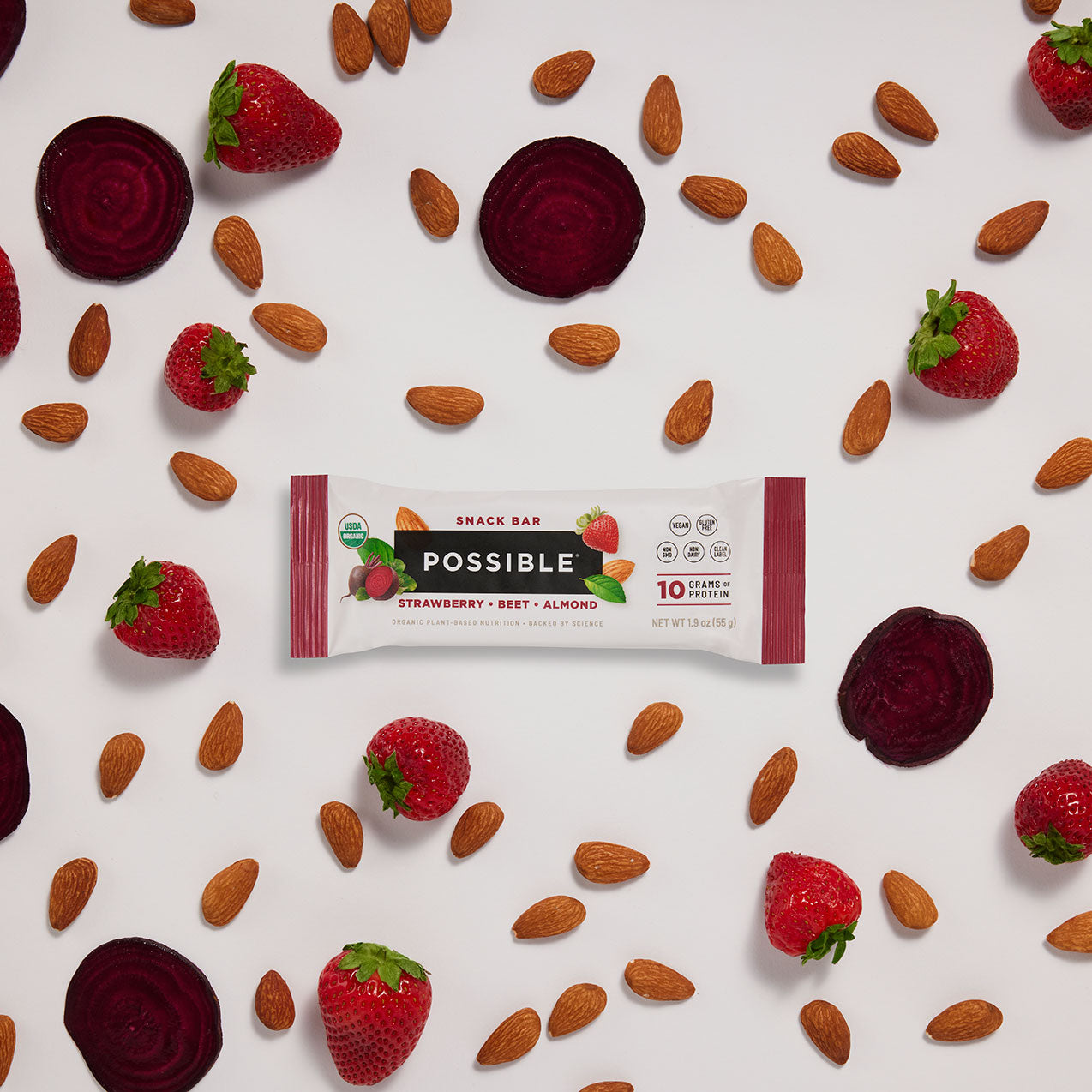 POSSIBLE Strawberry Beet Almond Snack Bar displayed with whole food ingredients, including fresh strawberries, sliced beets, and almonds, emphasizing natural plant-based nutrition.